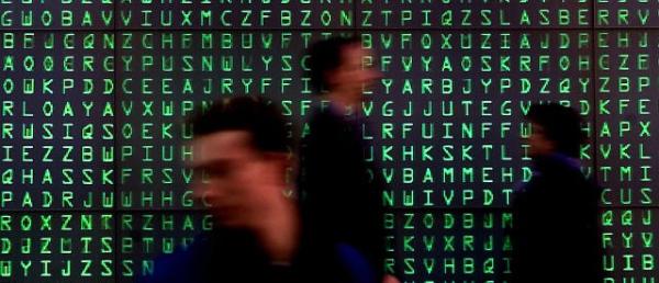 Visitors pass a giant Videoscreen with moving letters symbolising security codes at the computer- fair Cebit in Hanover March 22, 2001. About 8.000 exhibitors will present their products at the world