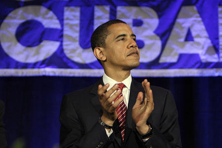 Democratic presidential hopeful, Sen. Barack Obama, D-Ill., listens to a speech from Jorge Mas Santos, Chairman of the Cuban American National Foundation at a Cuban Independence Day Celebration in Miami, Fla., Friday, May 23, 2008. (AP Photo/Chris Carlson)