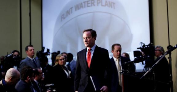 Michigan Attorney General Bill Schuette enters with the Flint Water Investigative Team to announce criminal charges resulting from the Attorney General's ongoing Flint Water Investigation on April 20, 2016 at the Riverfront Banquet Center in downtown Flint, Mich. (Ryan Garza/Detroit Free Press/TNS)