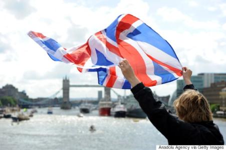 LONDON, UNITED KINGDOM - JUNE 15: A leave supporter is seen as fishing boats campaigning for Brexit sail down the Thames through central London, United Kingdom on June 15, 2016. A Brexit flotilla of fishing boats sailed up the River Thames into London today with foghorns sounding, during a protest against EU fishing quotas by the campaign for Britain to leave the European Union.  (Photo by Kate Green/Anadolu Agency/Getty Images)