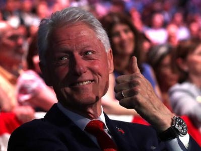 BROOKLYN, NY - JUNE 07: Former U.S. president Bill Clinton (R) gives the thumbs-up to his daughter Chelsea Clinton as his wife, Democratic presidential candidate former Secretary of State Hillary Clinton, speaks during a primary night event on June 7, 2016 in Brooklyn, New York. Hillary Clinton surpassed the number of delegates needed to become the Democratic nominee over rival Bernie Sanders with a win in the New Jersey presidential primary (Photo by Justin Sullivan/Getty Images)