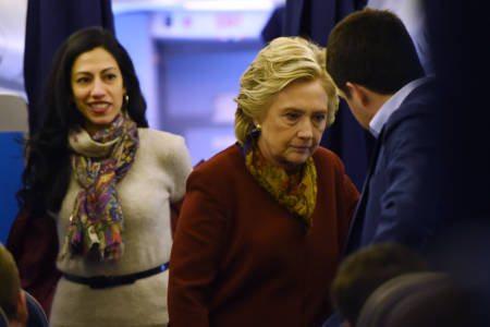 Democratic presidential nominee Hillary Clinton chats with her staff, including aide Huma Abedin (L), onboard her plane in White Plains, New York, October 22, 2016, on her way to a campaign event in Pittsburgh, Pennsylvania. / AFP / Robyn Beck (Photo credit should read ROBYN BECK/AFP/Getty Images)